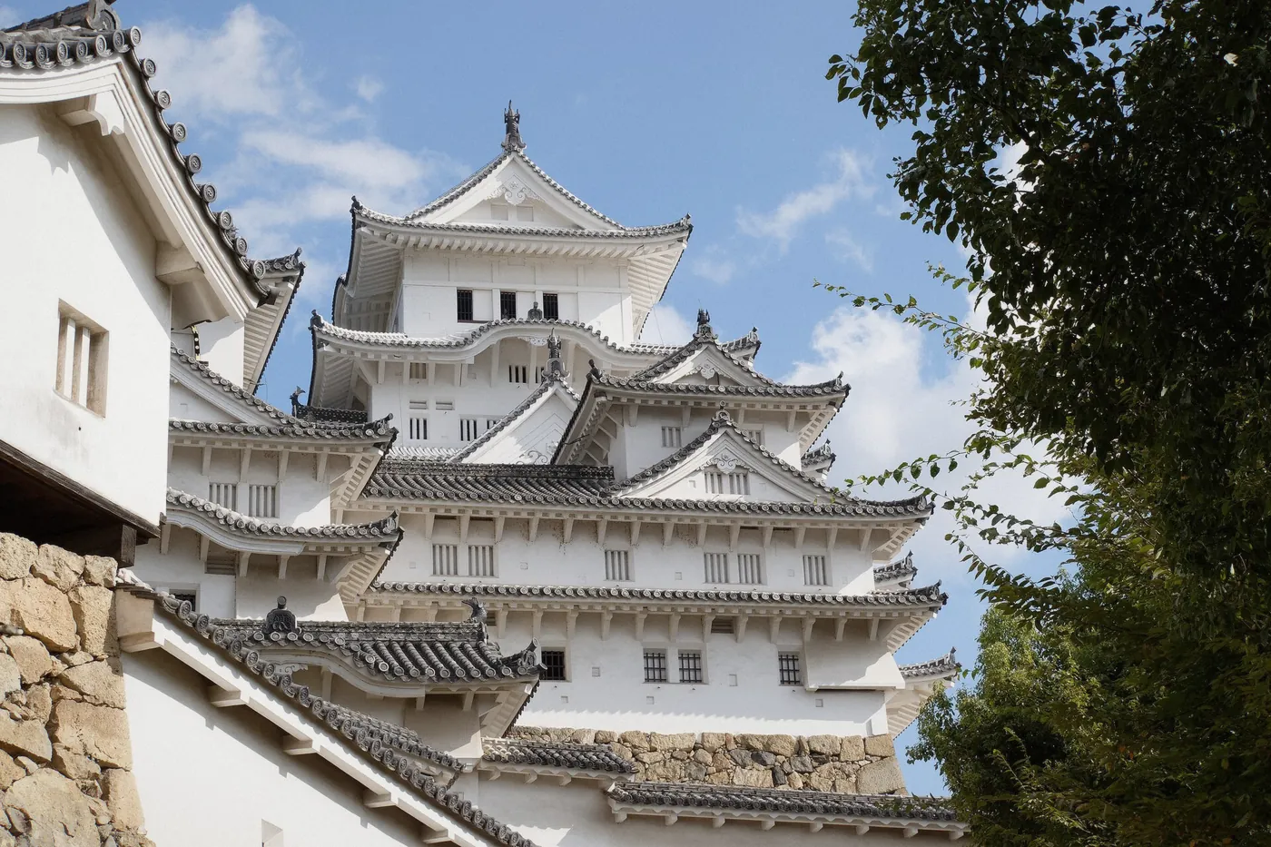 Himeji Castle keep above the roof tiles on the approach walk, Himeji, Japan