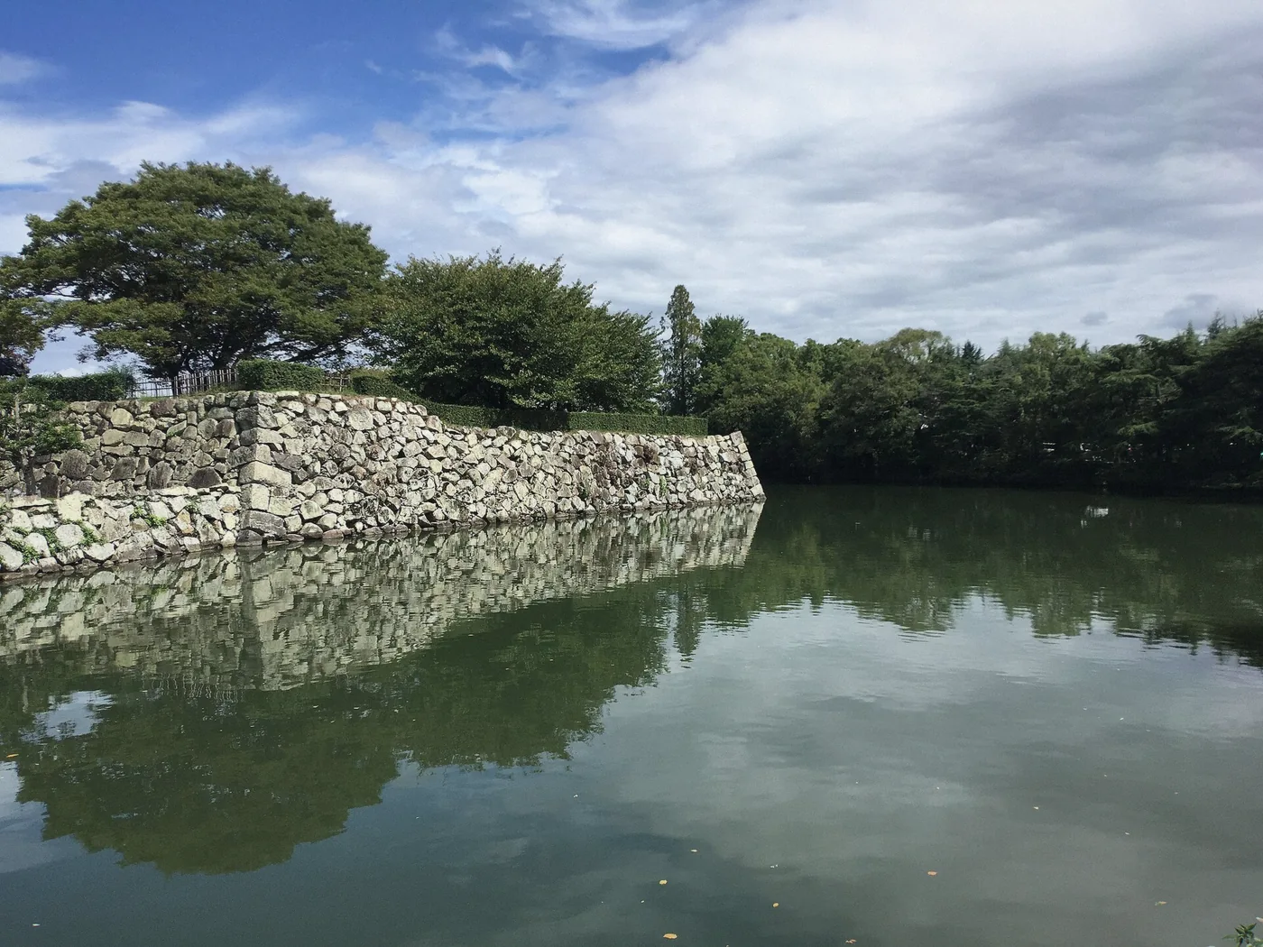 Moat and white walls of Himeji Castle seen from the approach in Himeji, Japan